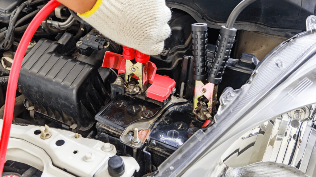 man jumpstarting a car